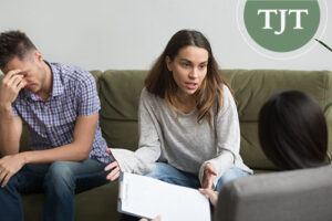 Worried parents speaking with a caseworker holding a clipboard during a DCPP interview in New Jersey